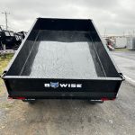 a Bwise dump trailer parked on the side of the road
