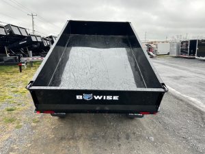 a Bwise dump trailer parked on the side of the road