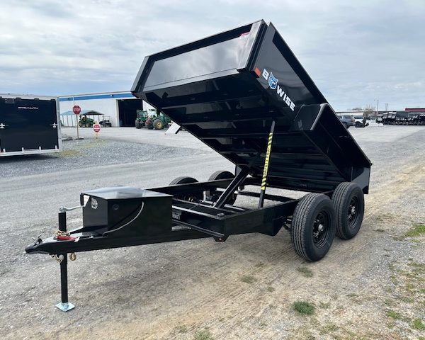 a dump trailer is parked on the side of the road