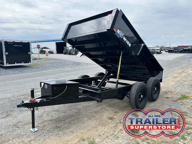 a dump trailer is parked on the side of the road
