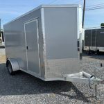 a gray trailer parked in a gravel lot