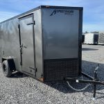 a homesteader trailer is parked in a gravel lot