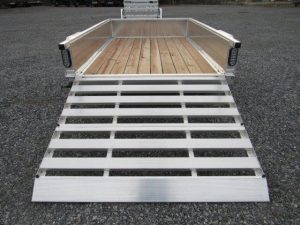 a trailer with a wooden deck and a ramp .