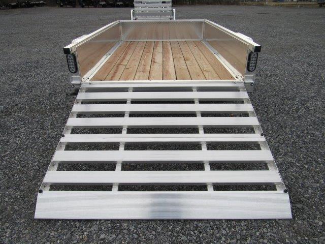 a trailer with a wooden deck and a ramp .