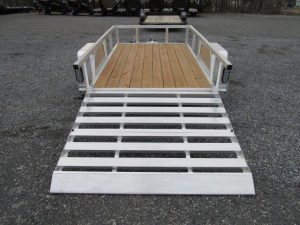 a trailer with a wooden deck and a white ramp