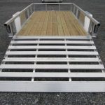 a trailer with a wooden deck and a silver ramp .