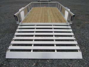 a trailer with a wooden deck and a silver ramp .