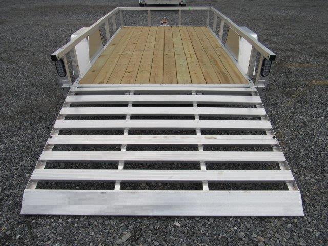 a trailer with a wooden deck and a silver ramp .
