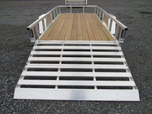a trailer with a wooden deck and a silver ramp .