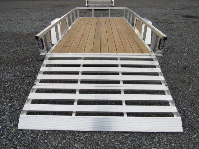 a trailer with a wooden deck and a silver ramp .