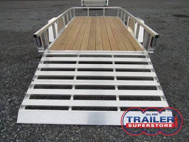 a trailer with a wooden deck and a silver ramp .
