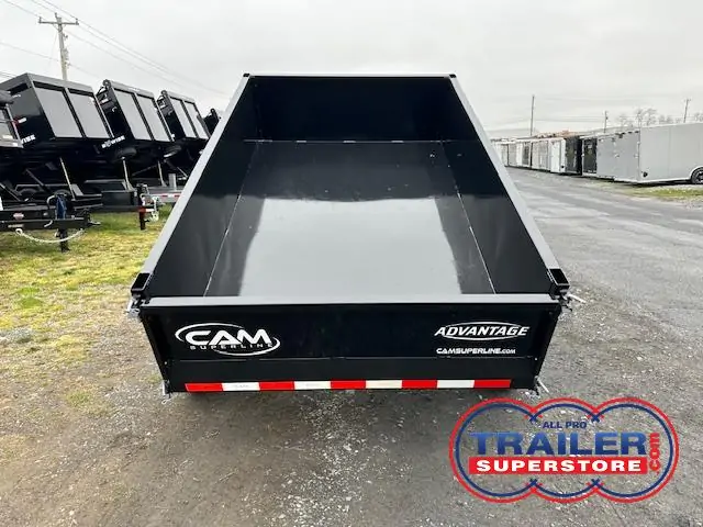 a black dump trailer parked on the side of the road