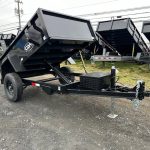 a cam dump trailer on the side of the road