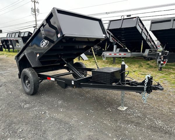 a cam dump trailer on the side of the road