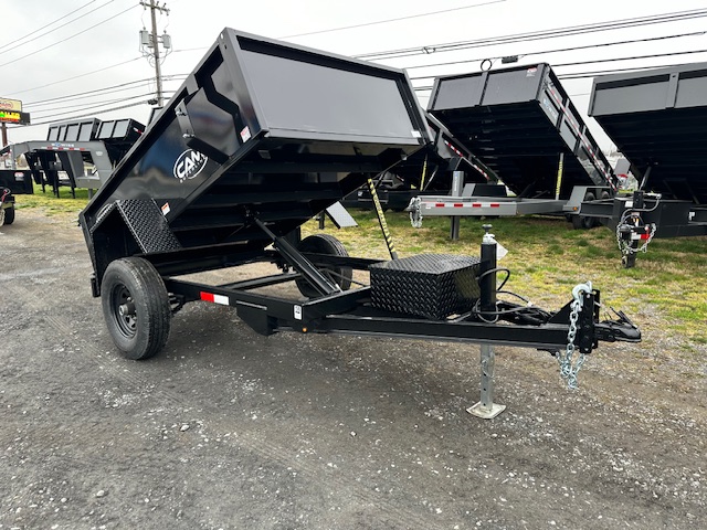 a cam dump trailer on the side of the road