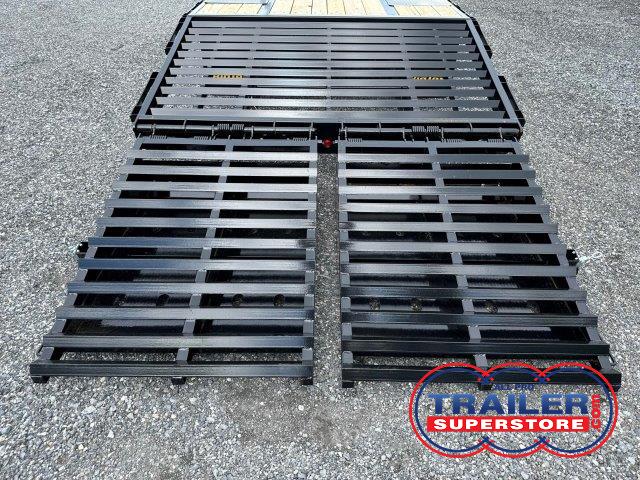 a black metal ramp is sitting on top of a gravel road .