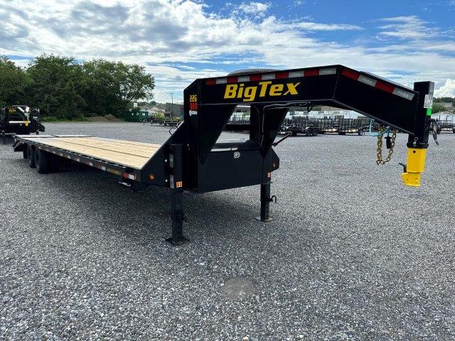 a BigTex flatbed trailer parked in a gravel lot