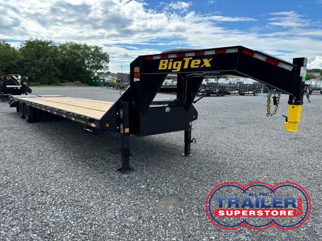 a BigTex flatbed trailer parked in a gravel lot