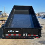 a dump trailer is parked on the side of the road .