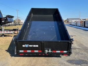 a dump trailer is parked on the side of the road .