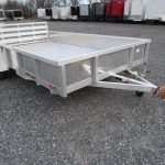 a Sport Haven aluminum landscape utility trailer is parked in a gravel lot