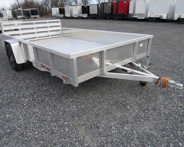 a Sport Haven aluminum landscape utility trailer is parked in a gravel lot