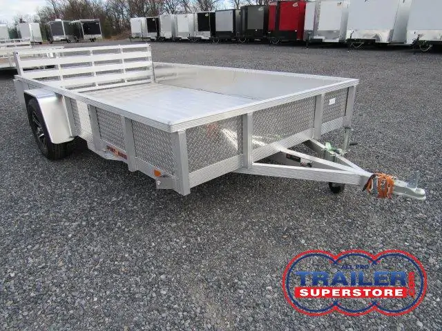 a Sport Haven aluminum landscape utility trailer is parked in a gravel lot