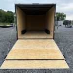 a Covered Wagon trailer with an enclosed V-nose and ramp door