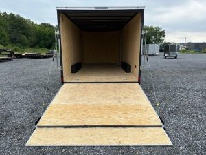 a Covered Wagon trailer with an enclosed V-nose and ramp door