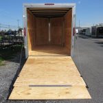 the inside of a Homesteader trailer with the door open and a wooden floor