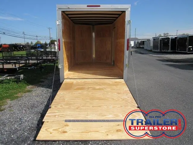 the inside of a Homesteader trailer with the door open and a wooden floor