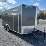 a gray trailer parked in a gravel lot