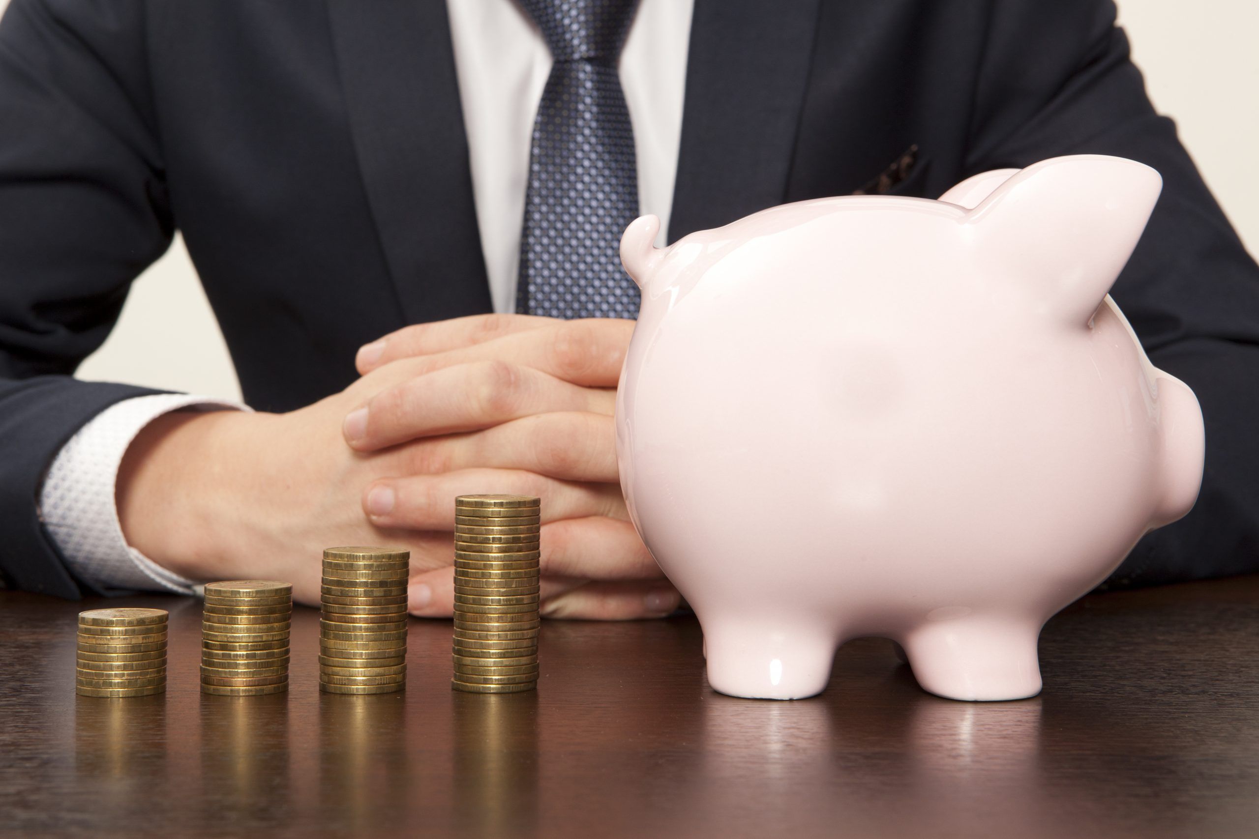 Businessman with pink piggy bank