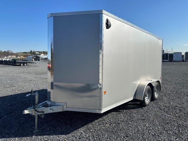 cargo trailer is parked in a gravel lot .