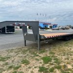 a BWise gooseneck deckover equipment trailer with a hydraulic tail