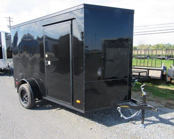 a black trailer parked on the side of the road