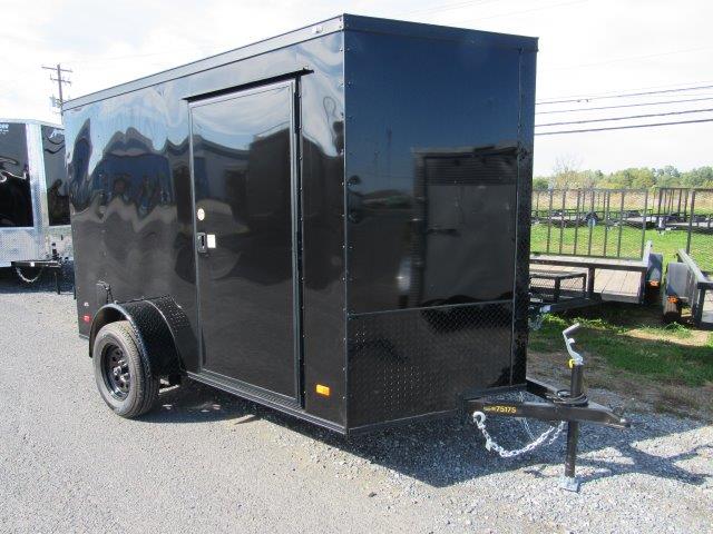 a black trailer parked on the side of the road