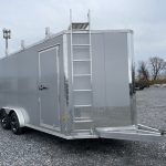 a silver trailer with a ladder attached to it