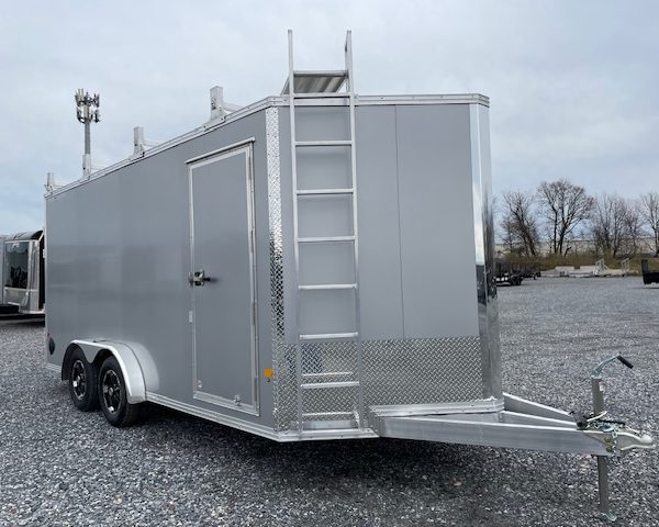 a silver trailer with a ladder attached to it