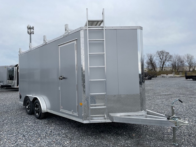 a silver trailer with a ladder attached to it