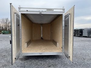 the inside of a Cargo Pro trailer with the doors open in a gravel lot