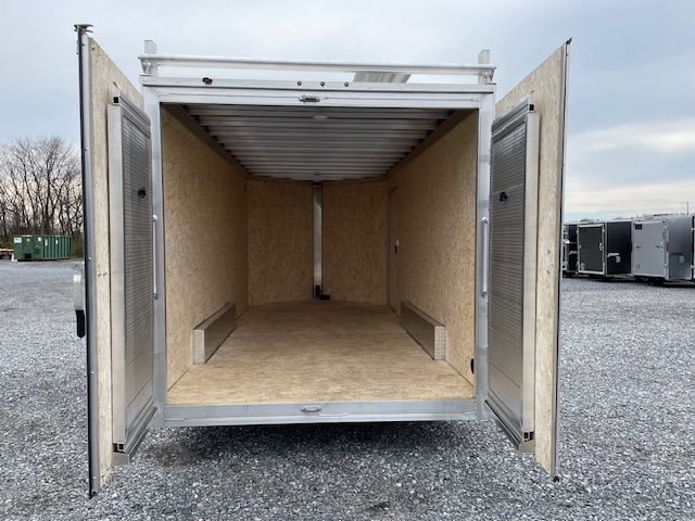 the inside of a Cargo Pro trailer with the doors open in a gravel lot