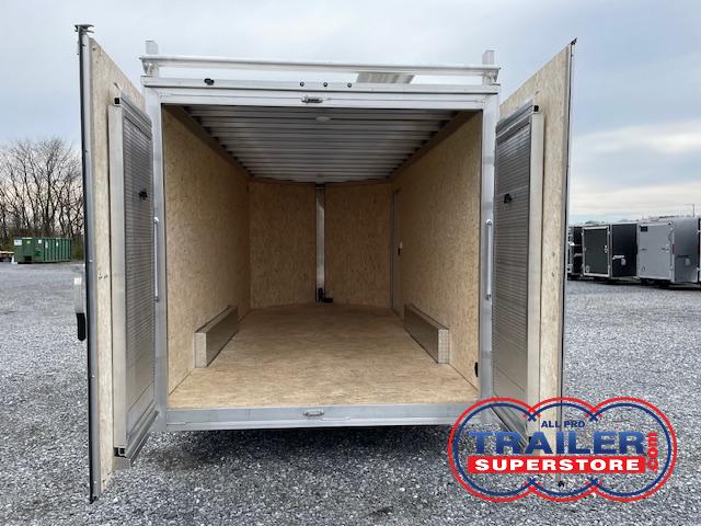 the inside of a Cargo Pro trailer with the doors open in a gravel lot