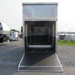 an ATC 8.5x26 trailer with the door open parked in a gravel lot