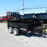 a black trailer parked on the side of the road