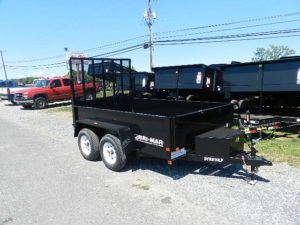 a black trailer parked on the side of the road