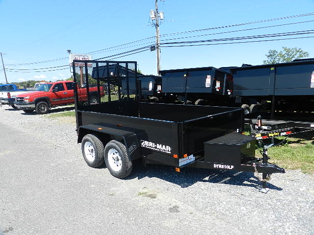 a black trailer parked on the side of the road