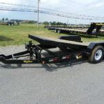 a black trailer parked on the side of the road