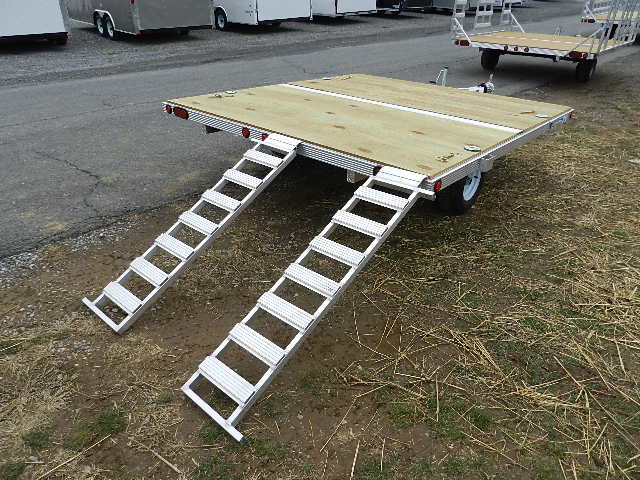 a trailer with a wooden deck and stairs attached to it