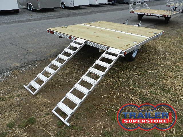 a trailer with a wooden deck and stairs attached to it